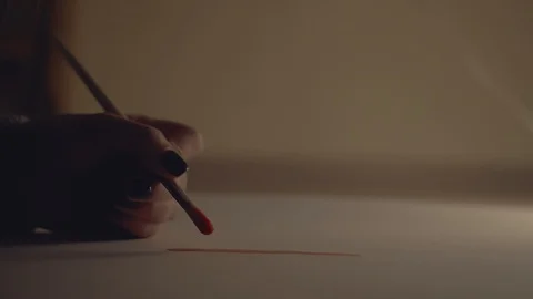 Brings on a white sheet. draws a red line. Close-up, macro. Stock Footage 99457808