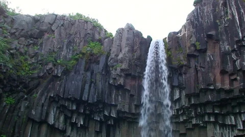 Brink of small waterfall on basalt column volcanic bedrock Stock Footage 38020512
