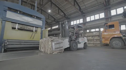 Briquette of raw material transported by loader to conveyor Stock Footage 290517362