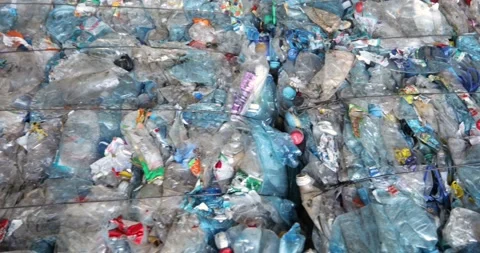 Briquettes of compressed plastic. Storage of solid waste for subsequent Stock Footage 156079573