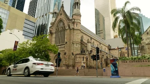 Brisbane traffic passes The Cathedral of St Stephenand skyscrapers 6K Video stock 329220175