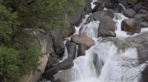 A brisk spring river rushes over rocks in Yosemite Stock Footage 62631547