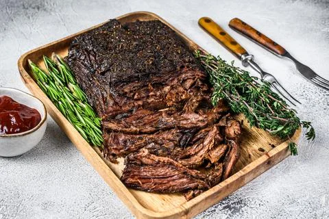 Brisket BBQ beef meat sliced on a wooden tray. White background. Top view Stock Photos