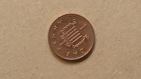 A British 1p con on brown background rotates Stock Footage 245832517