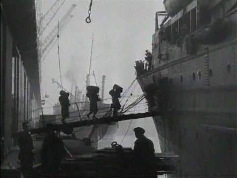 British and American troops board warships and travel in a convoy to invade Stock Footage 79459673