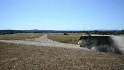 British Army Multiple Launch Rocket System travelling on dirt road  Stock Footage 201861867