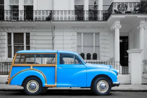 British blue oldtimer from 50s or 60s in front of white Victorian facades Stock Photos
