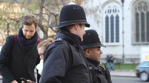 British bobbies converse in front of Westminister Abbey Stock-Footage 33422374