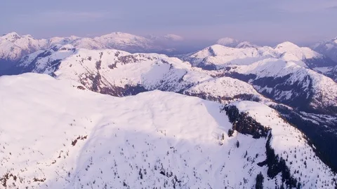 British Columbia, Canada circa-2018. Aerial view of snow covered mountain range. Stock Footage
