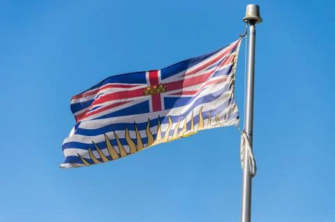 British Columbia flag waving over blue sky in Vancouver, BC, Canada Stock Photos