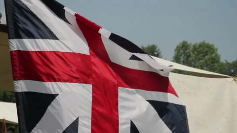 British Flag catches wind in the sun on an 18th century Battlefield Stock Footage 170447949