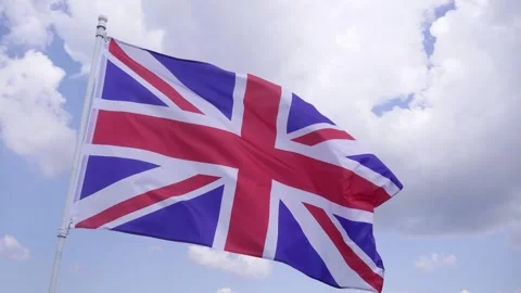 The British Flag Flies Under Blue Clouds. Stock Footage 311376093