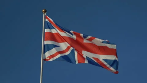The British flag flutters in the wind. Against the blue sky. Stock Footage 158951668