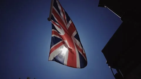 British flag, the union jack in slow motion with sunshine 스톡 동영상 130910597