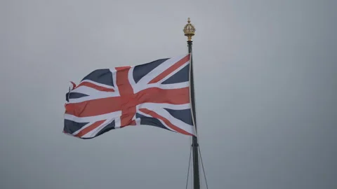 A British flag (Union Jack) waving on a pole. Stock Footage 309155437
