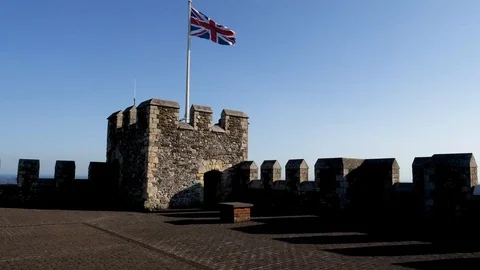 British flag waves over ramparts of Dover Castle Stock Footage 95565372