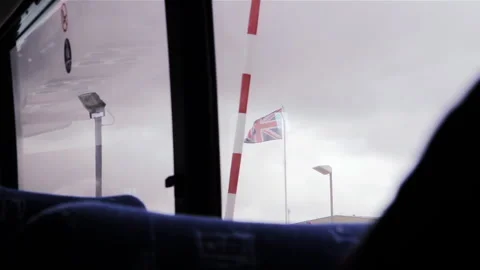 British Flag Waving Outside Passenger Bus Window From Airport In Falklands - 4K Stock Footage 344426651