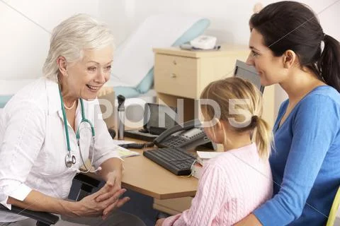 British GP talking to young child and mother Stock Photos