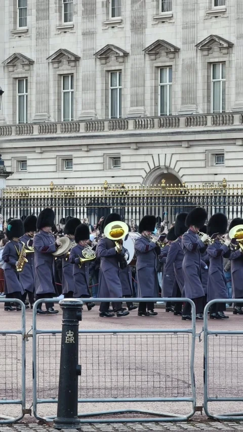 British guards standing in formation outside Buckingham Palace Stock Footage 323591348