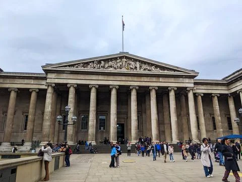 British Museum facade with ionic columns and sculptures, people visiting on a Stock Photos
