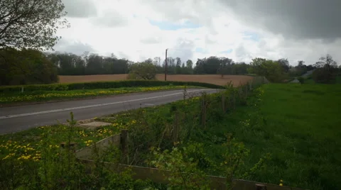 A British NHS Ambulance on blue flashing lights Stock Footage