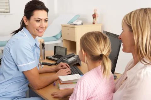 British nurse talking to young child and mother Stock Photos