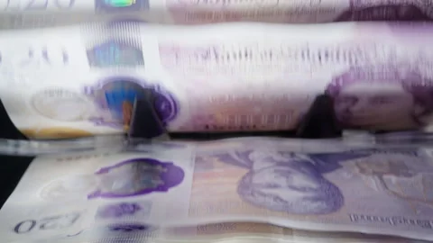 British pound banknotes being counted and verified by an automatic cash counter. Stock Footage 341767885