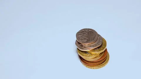 British pound coins put on a table on a white background Stock Footage 234142353