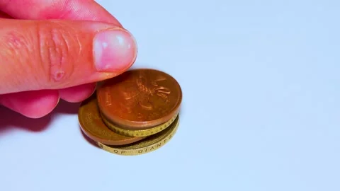 British pound coins put on a table on a white background Stock Footage 234142448
