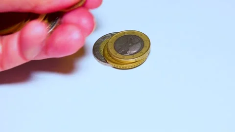 British pound coins put on a table on a white background Stock Footage 234142452
