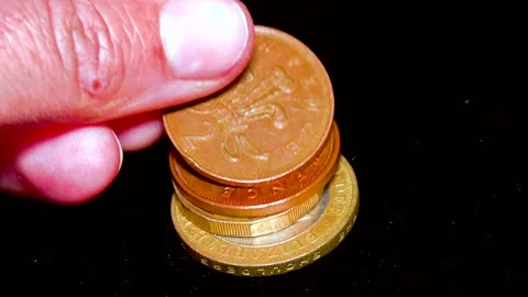 British pound coins put on a table on a white background Stock Footage 234142504