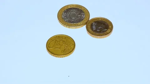 British pound coins put on a table on a white background Stock Footage 234142575