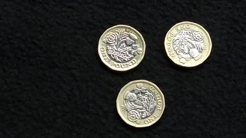 British pound coins on surface being reduced to zero Stock Footage 245096229