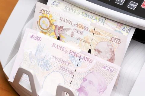 British pound in the counting machinej Stock Photos