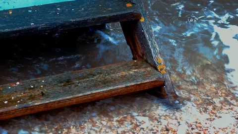 BRITISH SEASIDE BEACH HUT STEP IN THE WATER - QUICKTIME - 4K Stock Footage 126907356