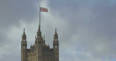 British Union Flag flies on top of the Houses of Parliament Stock Footage 258655736