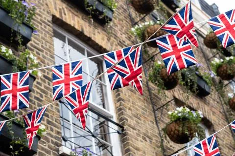 British Union Jack flag triangular hanging in preparation for a street party Stock Photos