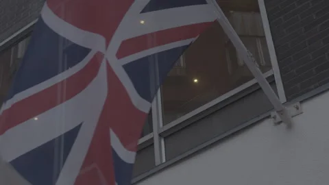 British Union Jack Flag Waving on Building Facade Stock Footage 342565624