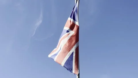 British union jack waving against sky detail Stockbeeldmateriaal 335776737