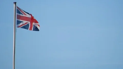 BritishFlagUnionJackBlowinginWindBlueSky Stock Footage 105880319