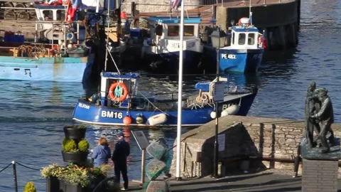 Brixham, Devon: Trawler sails past 'Man and Boy' SLOMO (MUTE) Stock Footage 141447461