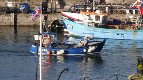 Brixham, Devon: Trawler sails past the 'Man and Boy' public statue (MUTE) Stock Footage 141447465