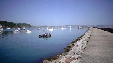 Brixham Harbour, Devon England. The breakwater and features Stock Footage 133359723