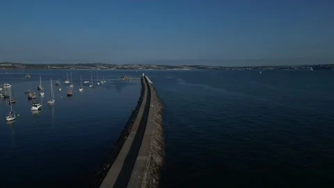 Brixham, S. Devon, England: DRONE VIEWS: Brixham harbour lighthouse &amp; Wall (1) Stock Footage 265173753