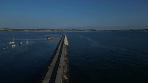 Brixham, S. Devon, England: DRONE VIEWS: Brixham harbour lighthouse &amp; Wall (2) Stock Footage 265173755