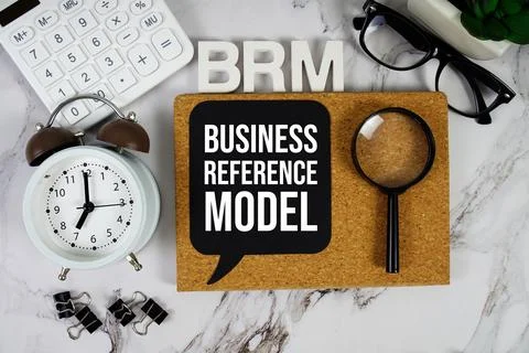 BRM - Business Reference Model acronym with calculator, alarm clock and mag.. Foto stock
