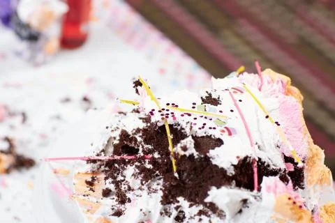 Broached birthday cake on table Stock Photos