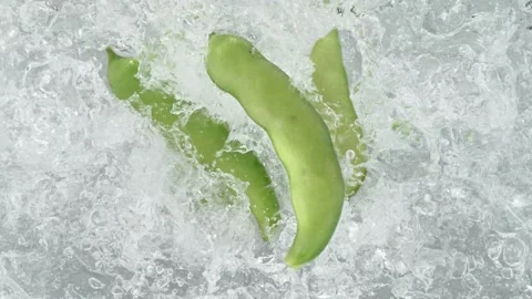 Broad Bean Pods Falling into Pot of Boiling Water Stock Footage 271400044
