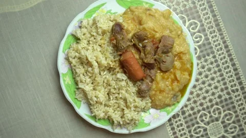 Broad bean stew with rice and hamburger viewed from above, typical peruvian food Stock Footage 139831731