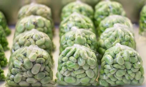 Broad beans inside plastic bags. Stock Photos